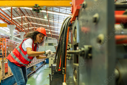 Technicians or workers are working in a metal sheet factory.