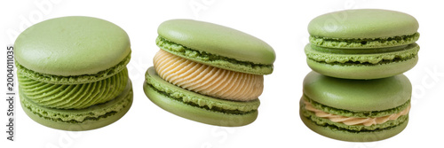 Three green macaron cookies with cream filling isolated on a white background, for dessert