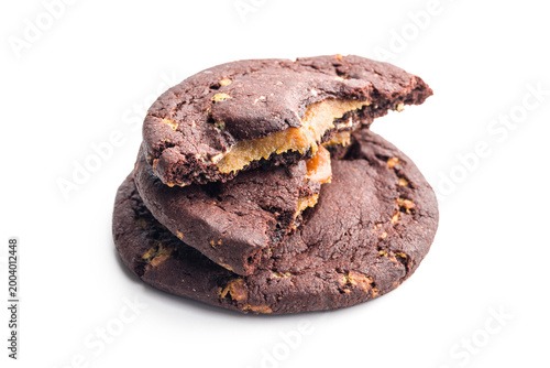 Schilderij op canvas Chocolate Cookies With Caramel Filling Stacked and Broken Bite on White Backgrou