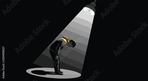 Emotional concept featuring a solitary person standing under a bright spotlight in the dark representing loneliness or being the center of attention.