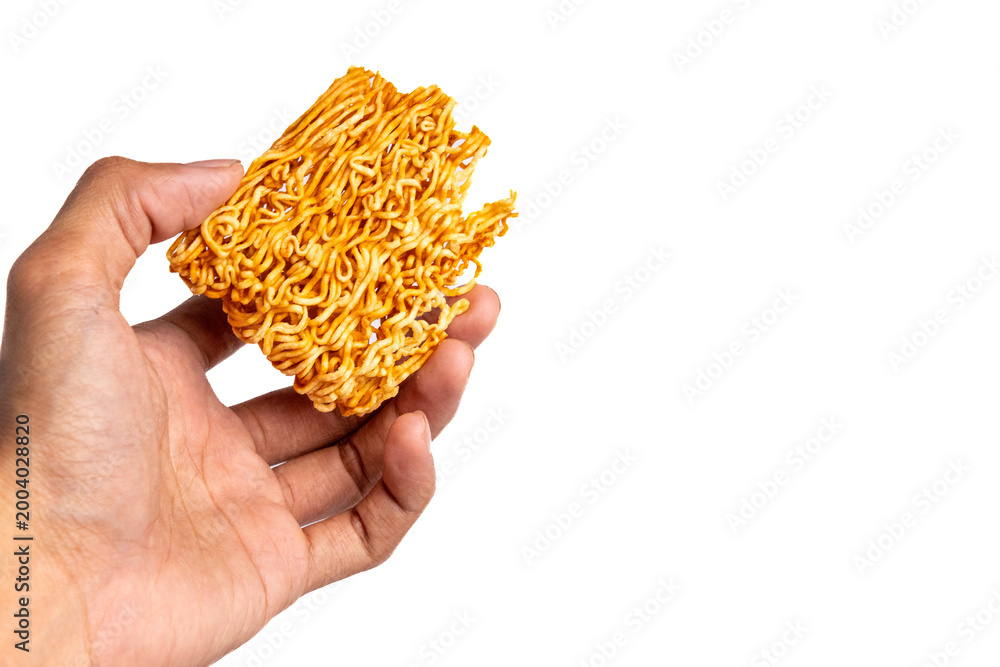 Fototapeta premium Hand holding a piece of spicy dry instant noodle block isolated on white background