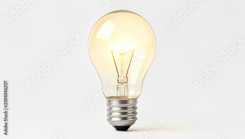 A single light bulb casting a warm glow against a neutral background.