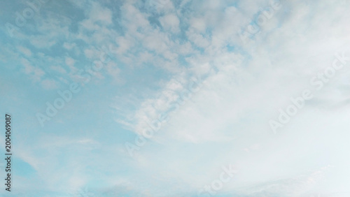 Fotografie Minimalist Bright Blue Sky with Soft White Clouds Background