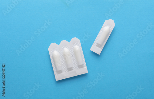 Rectal suppositories on a blue background