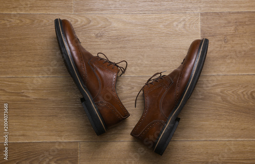 Fotografie Man's Classic leather brown brogue shoes on floor. Top view