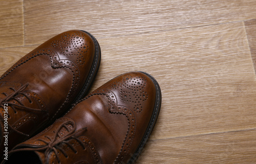Obraz na plátně Man's Classic leather brown brogue shoes on floor. Top view