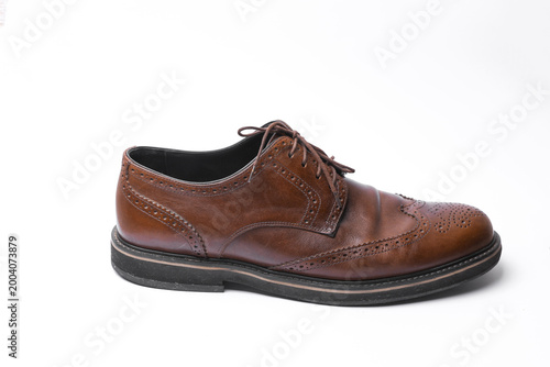 Photography Man's Classic leather brown brogue shoe on white background.