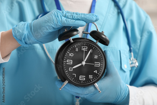 Female doctor with alarm cl...