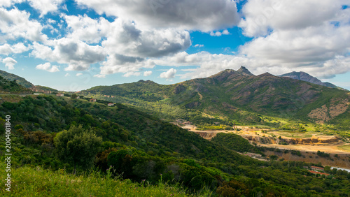 Panoramic view of Montevecchio, abandoned mining village in southwest Sardinia, with lush green hills around it, Italy