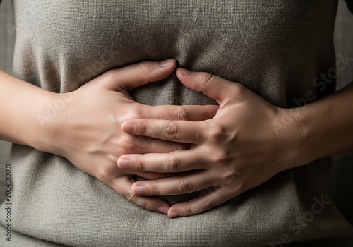Close Up Of Woman Pressing Her Abdomen Showing Signs Of Severe Stomach Pain And Bloating