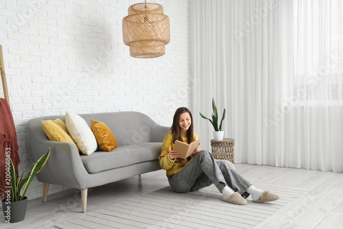 Young happy woman with book...