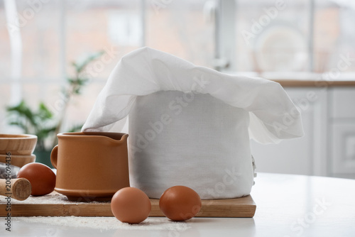 Chef's hat, eggs and utensi...