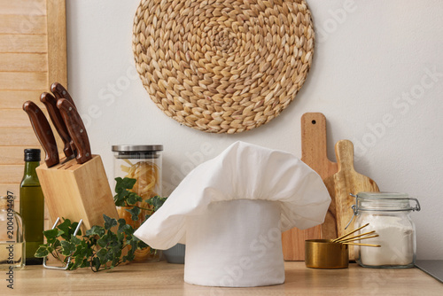 Chef's hat and utensils on ...
