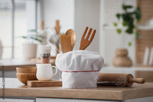 Chef's hat and utensils on ...