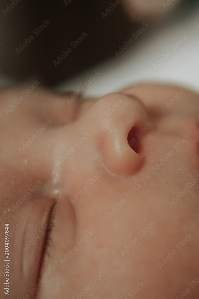 Naklejka premium baby's nose in close-up, macro photography, newborn's face