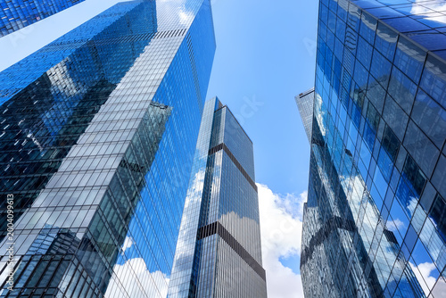 View of modern glass skyscrapers in financial district. Contemporary corporate architecture symbolizing business, finance and urban development.