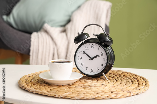 Alarm clock and cup of coff...