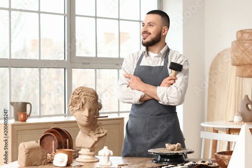 Young male sculptor with ca...