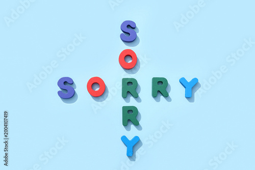 Foto Words SORRY made from colorful letters on blue background