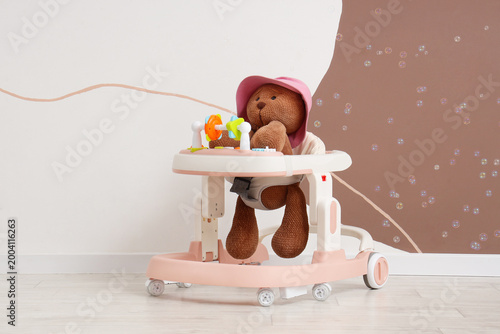 Baby walker with plush bear...