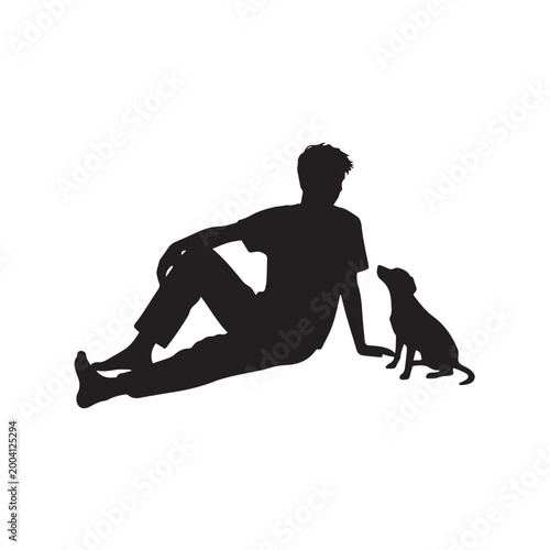 Silhouette of a Young Man Sitting on the Ground With His Small Puppy.