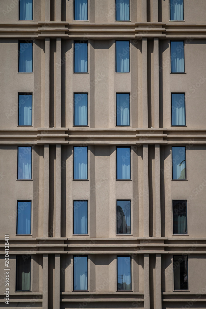 Obraz premium Plain facade with narrow vertical windows, Palermo, Sicily, Italy