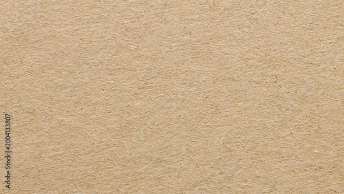 Natural beige kraft paper texture background with recycled fibrous surface for eco friendly backdrop