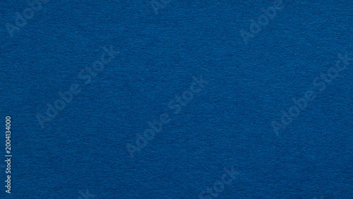 Deep blue paper texture background with fibrous surface for solid color backdrop with copy space