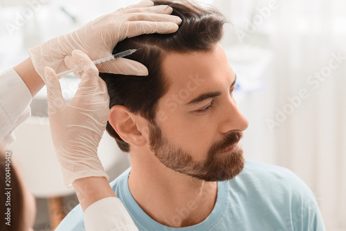 Doctor giving man injection...