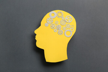 Paper human head with gears on dark grey background. World Mental Health Day