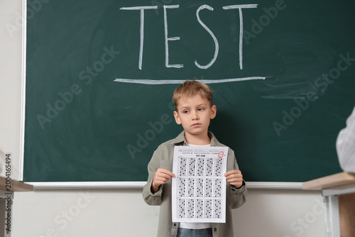 Sad schoolboy with results ...