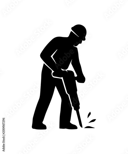 Construction worker in hard hat using a jackhammer creating debris