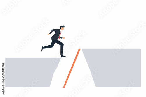 Businessman jumps over gap using ladder over chasm
