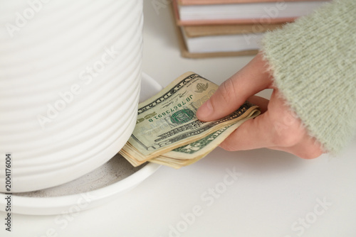 Woman hiding dollar banknot...