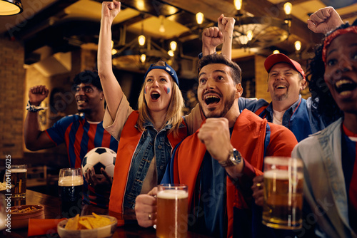 Passionate fans celebrating their team's victory during soccer championship.