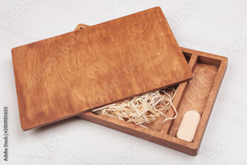 Slika na platnu Wooden photo box for photo storage on straw background