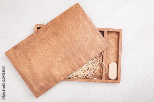 Slika na platnu Wooden photo box for photo storage on straw background
