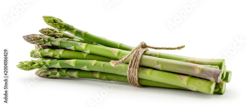 A bundle of fresh green asparagus spears tied together with a piece of brown twine on white