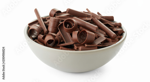 A ceramic bowl filled with thin chocolate shavings and curls on a white background