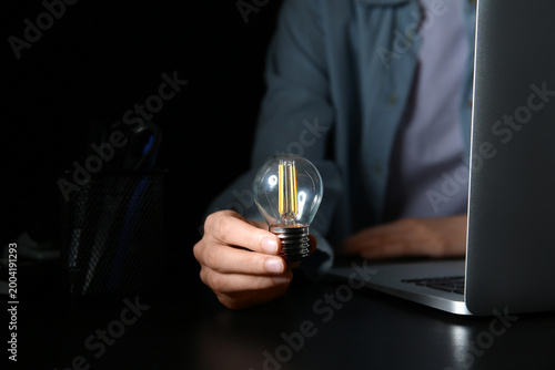 Woman with light bulb using...