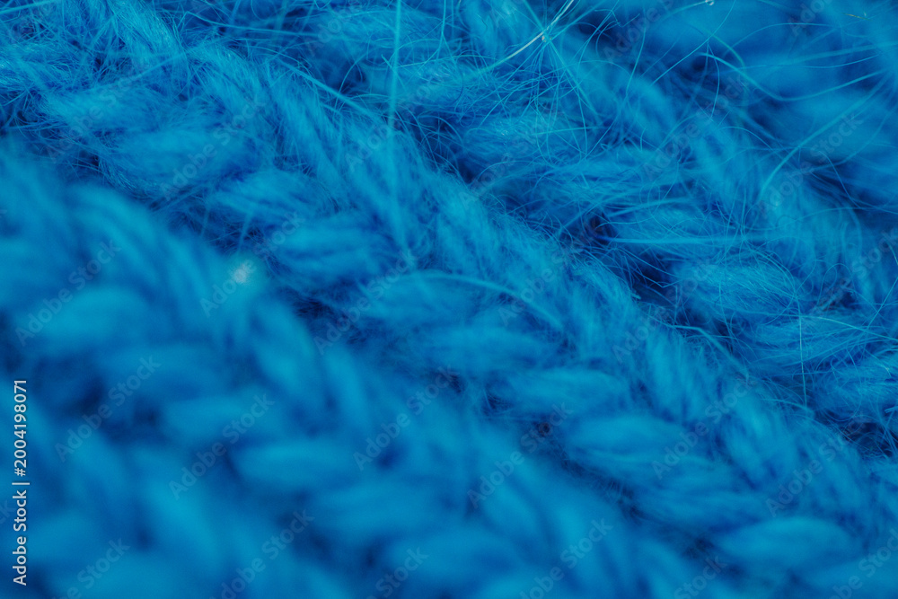 Obraz premium Blue knitted fabric texture close up, soft textile pattern, abstract background, cozy material concept.