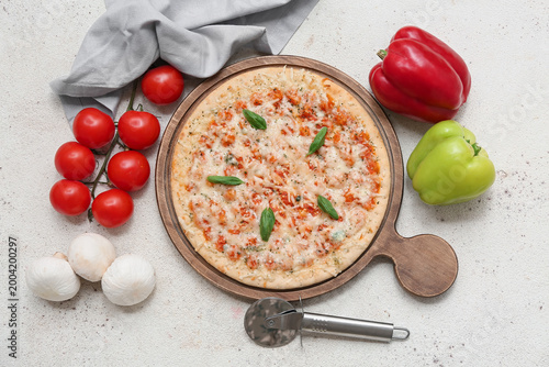 Tasty pizza, cutter and ing...