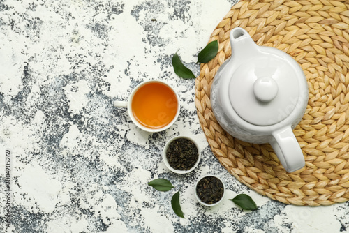 Cup and teapot of hot tea w...