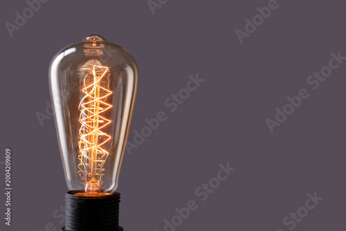Glowing retro light bulb on...