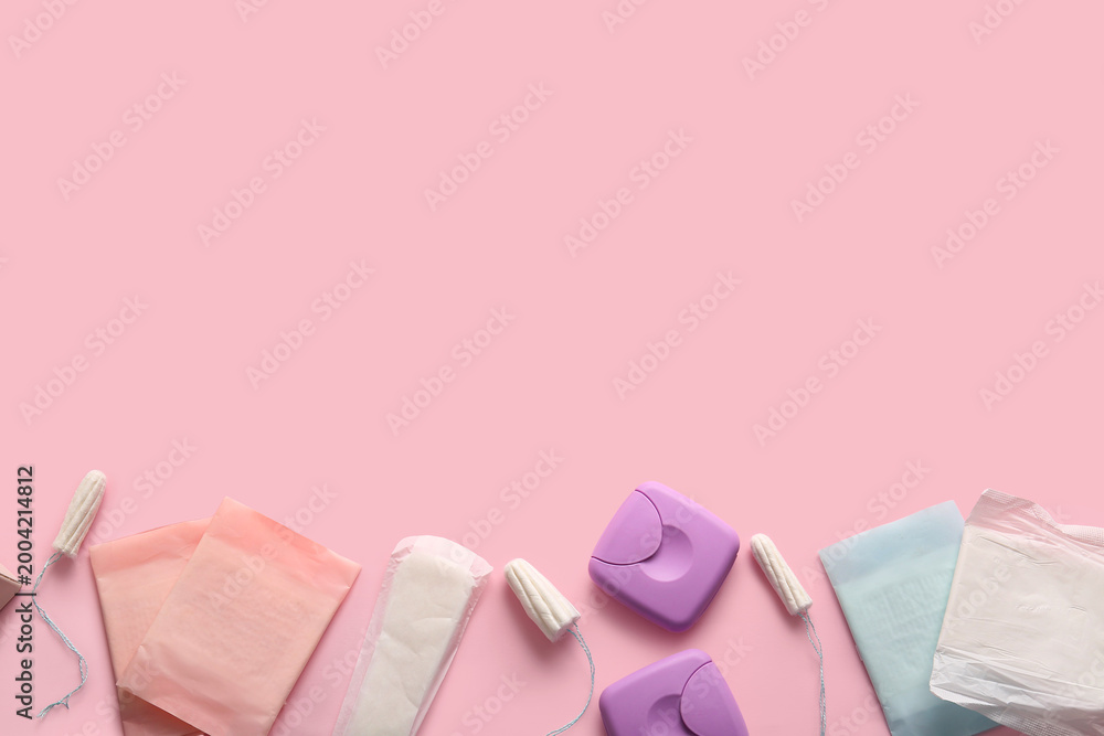 Obraz premium Menstrual pads with tampons and storage boxes on pink background
