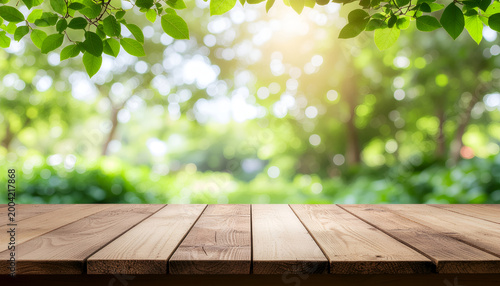 Wooden table with sunny garden bokeh background.