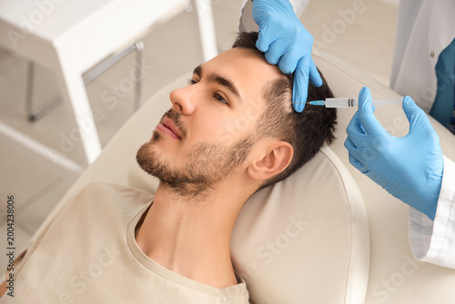 Young man receiving injecti...