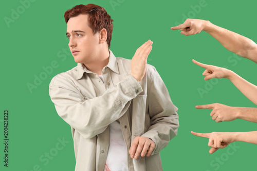 Photos People pointing at young man on green background