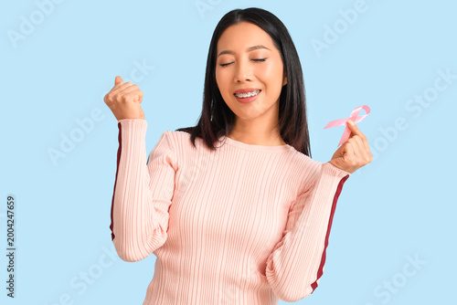 Young Asian woman with pink...