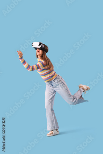 Young woman in VR glasses r...
